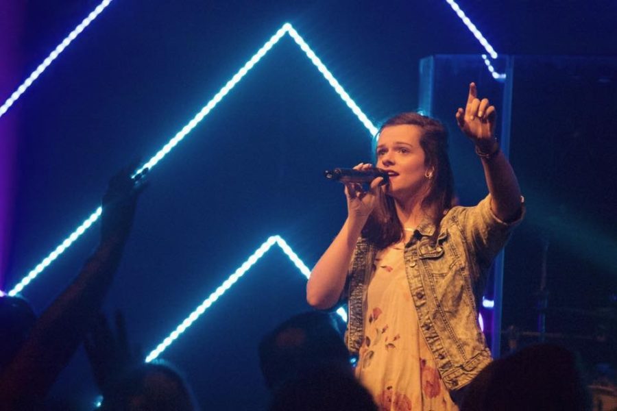 Anna Penwell, combining two of her best traits, leadership and singing, by  leading worship at her church. 