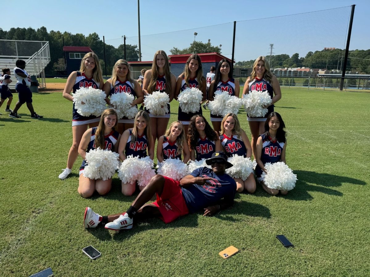 Coach Mo poses with our cheerleaders