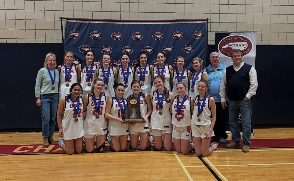 The varsity girls basketball team with their coaches.