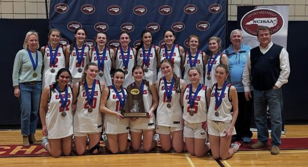 The varsity girls basketball team with their coaches.