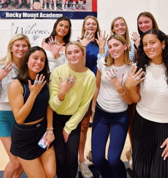 Varsity girls basketball players show off their new hardware.